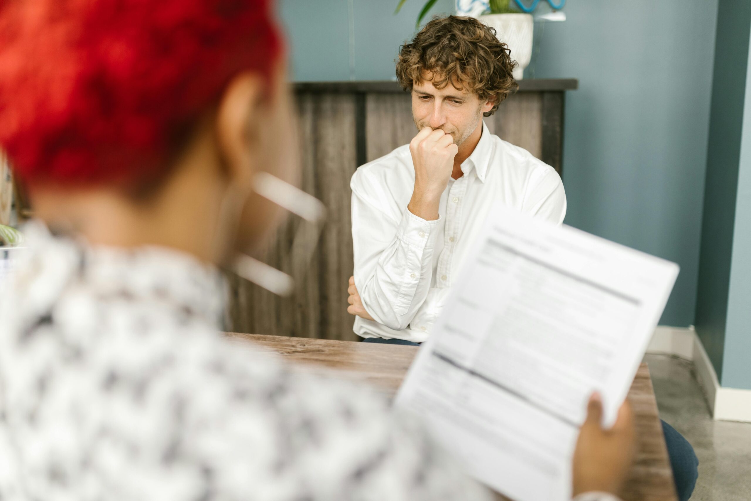 Two people in discussion, illustrating the role of a Co-Decision Maker providing guidance.